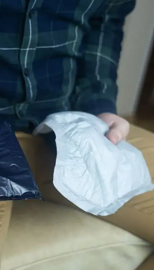 Image of man holding incontinence pads as part of overactive bladder treatment Bristol