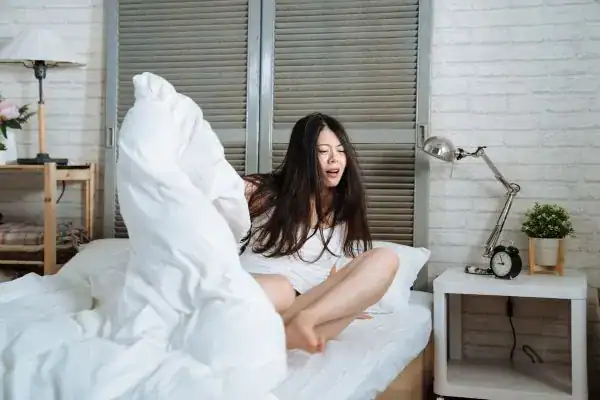 Image of woman getting up because of nighttime leaks Bristol